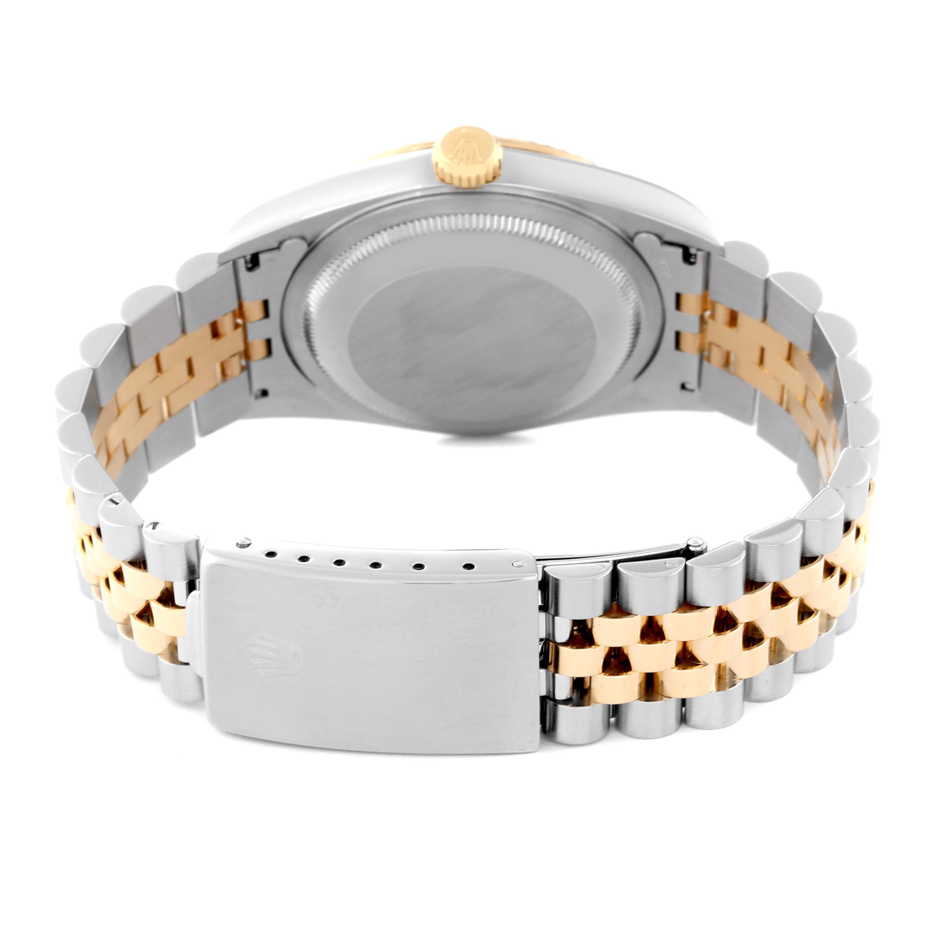 The image shows the back view of a Rolex Datejust 16233 Men's Steel and Gold (two tone) White Dial 16233 Men's Steel and Gold (two tone) White Dial watch, highlighting its case back, crown, and two-toned bracelet with a clasp.