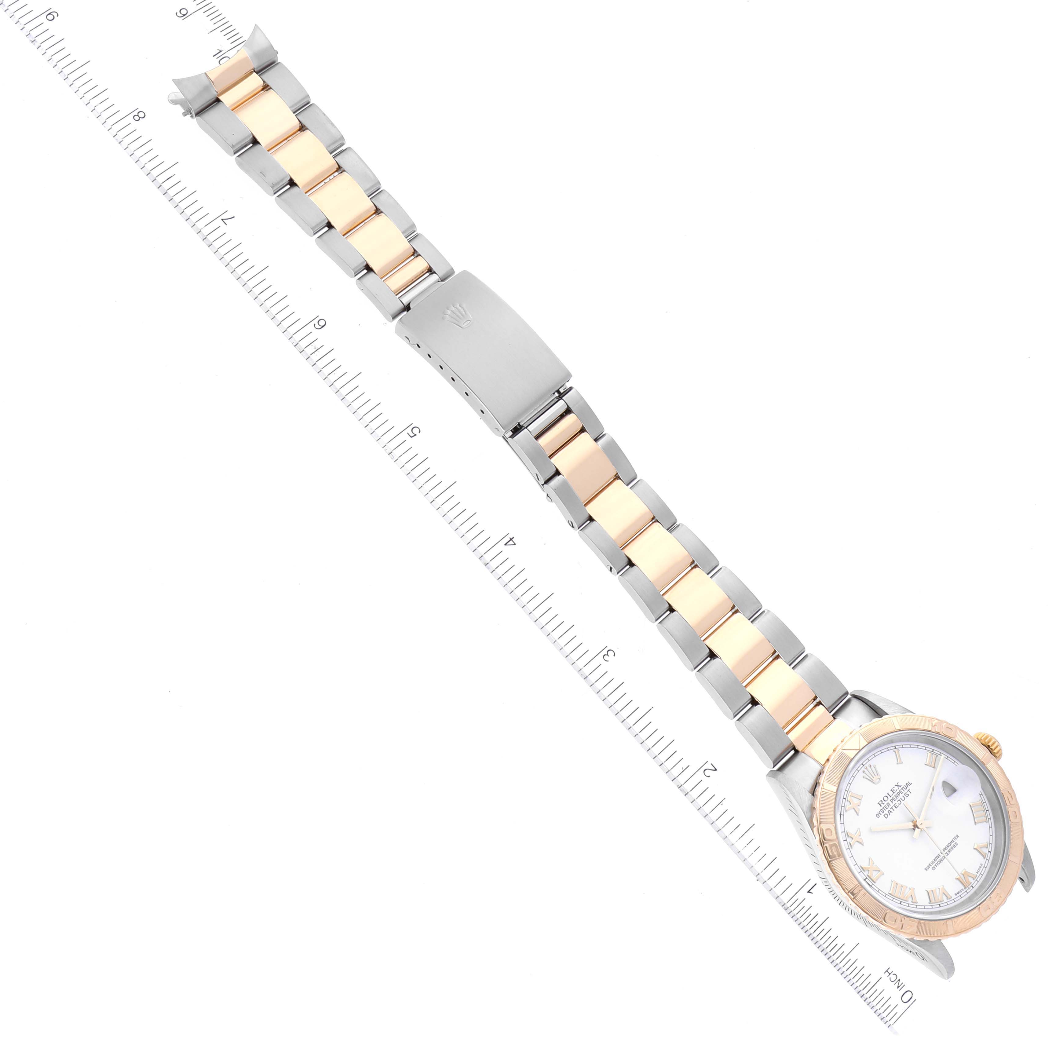 The image shows a top-down view of a Rolex Turn-o-Graph 16263 Men
s Steel and Gold (two tone) White Dial 16263 Men
s Steel and Gold (two tone) White Dial watch, including the face, bracelet, and clasp, alongside a measuring ruler.