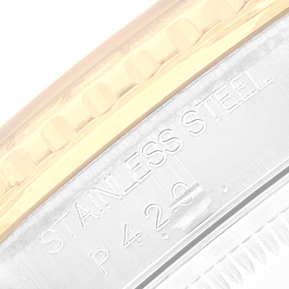 The image shows a close-up of the side of a Rolex Turn-o-Graph 16263 Men
s Steel and Gold (two tone) White Dial 16263 Men
s Steel and Gold (two tone) White Dial watch, highlighting the stainless steel and gold bezel with engraved details.