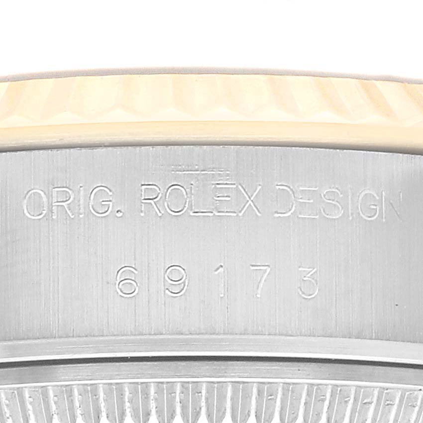 This image shows a close-up of the case side engraving on a Rolex Datejust 69173 Women's Steel and Gold (two tone) Blue Dial 69173 Women's Steel and Gold (two tone) Blue Dial watch, displaying its model details and design.