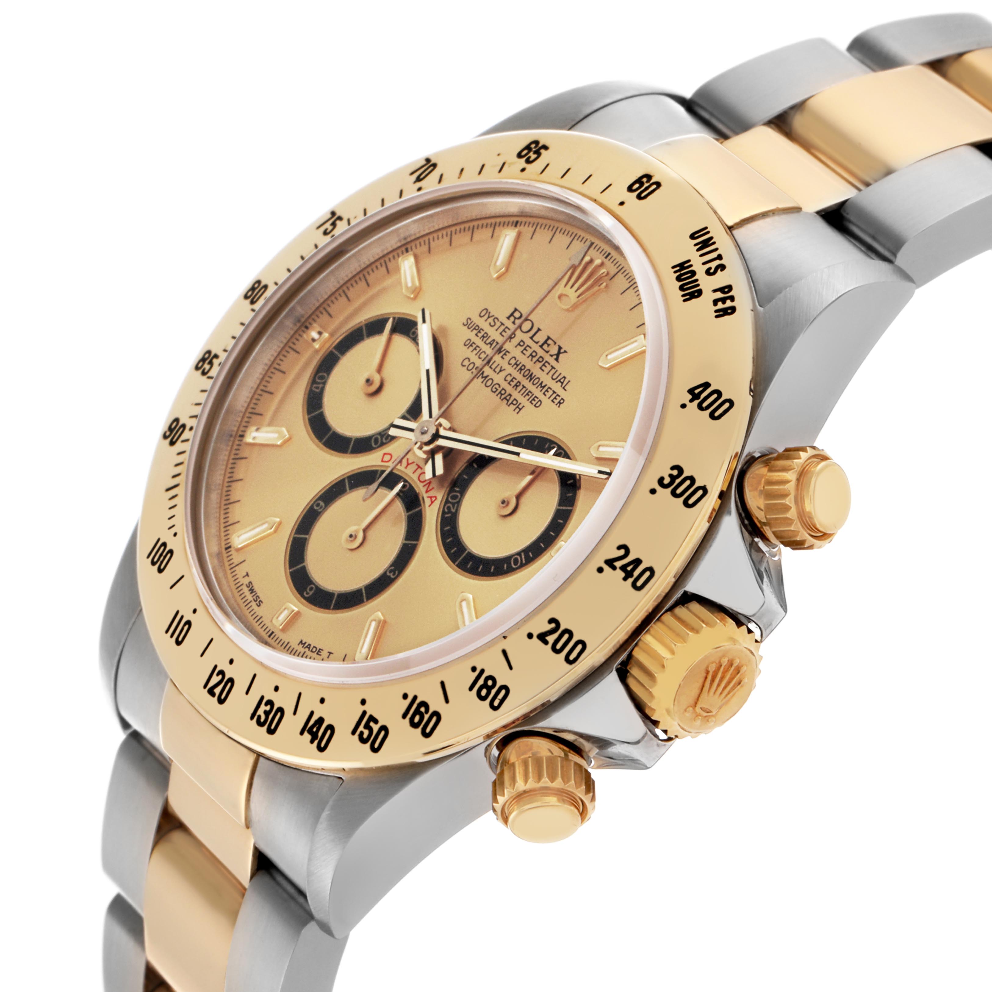 The Rolex Daytona 16523 Men's Steel and Gold (two tone) Champagne Dial 16523 Men's Steel and Gold (two tone) Champagne Dial watch is shown at a tilted angle, displaying the face, bezel with tachymetric scale, crown, and part of the bracelet.