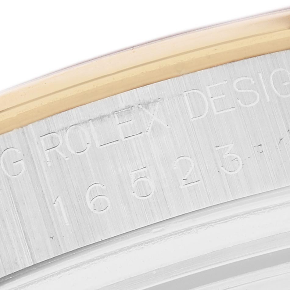 The image shows the edge of the case back of a Rolex Daytona 16523 Men's Steel and Gold (two tone) Champagne Dial 16523 Men's Steel and Gold (two tone) Champagne Dial, focusing on its engraved design and reference number.