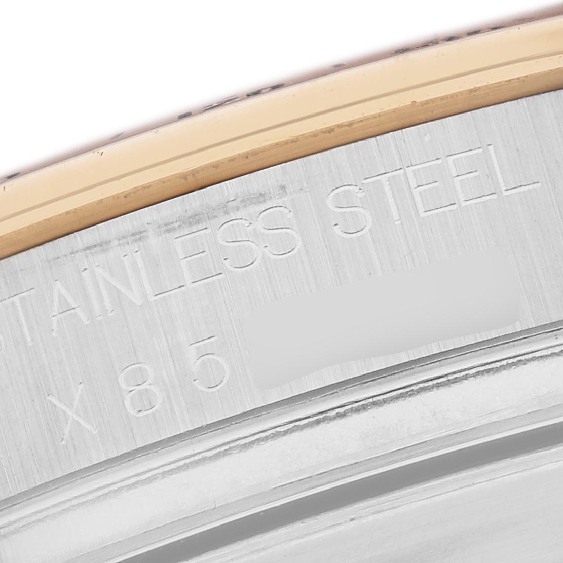 The image shows a close-up of the Rolex Daytona 16523 Men's Steel and Gold (two tone) Champagne Dial 16523 Men's Steel and Gold (two tone) Champagne Dial's case side, highlighting "STAINLESS STEEL" engraving.