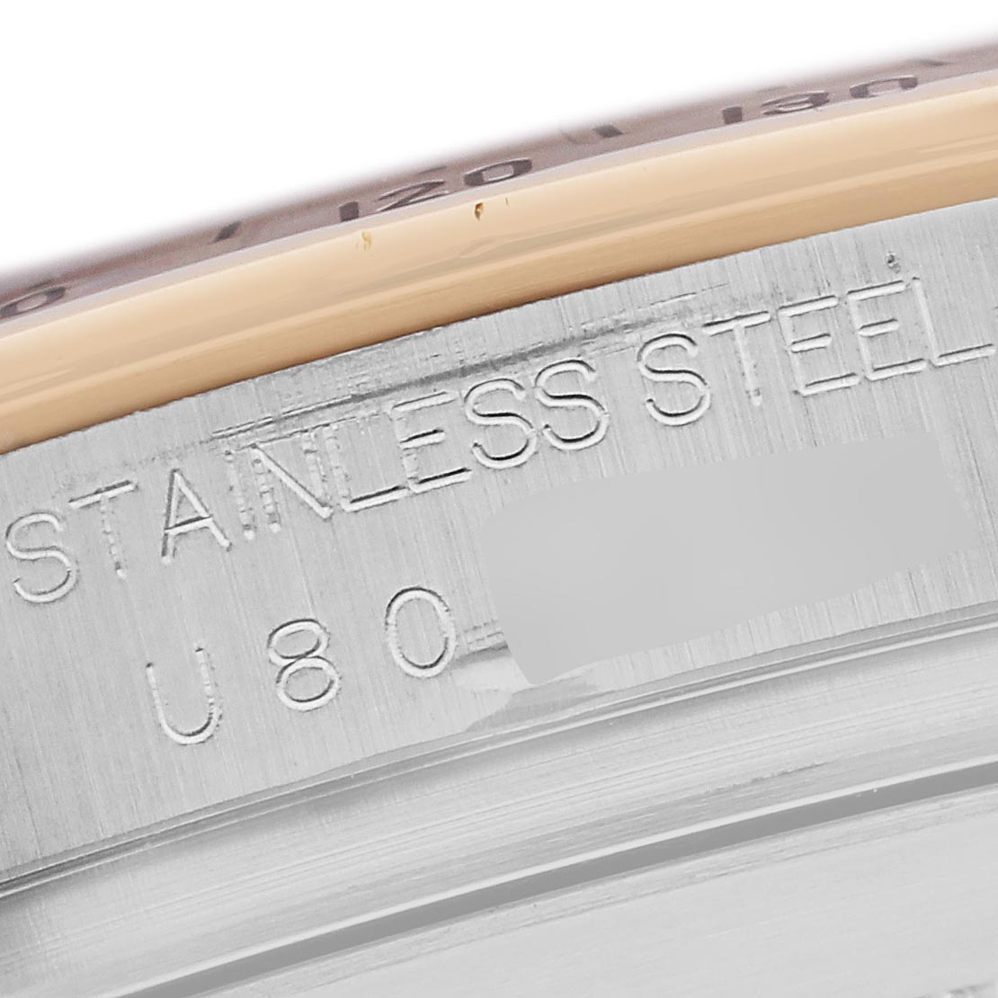 The image shows a close-up of the case edge with "STAINLESS STEEL" engraving on a Rolex Daytona 16523 Men's Steel and Gold (two tone) Black Dial 16523 Men's Steel and Gold (two tone) Black Dial watch.