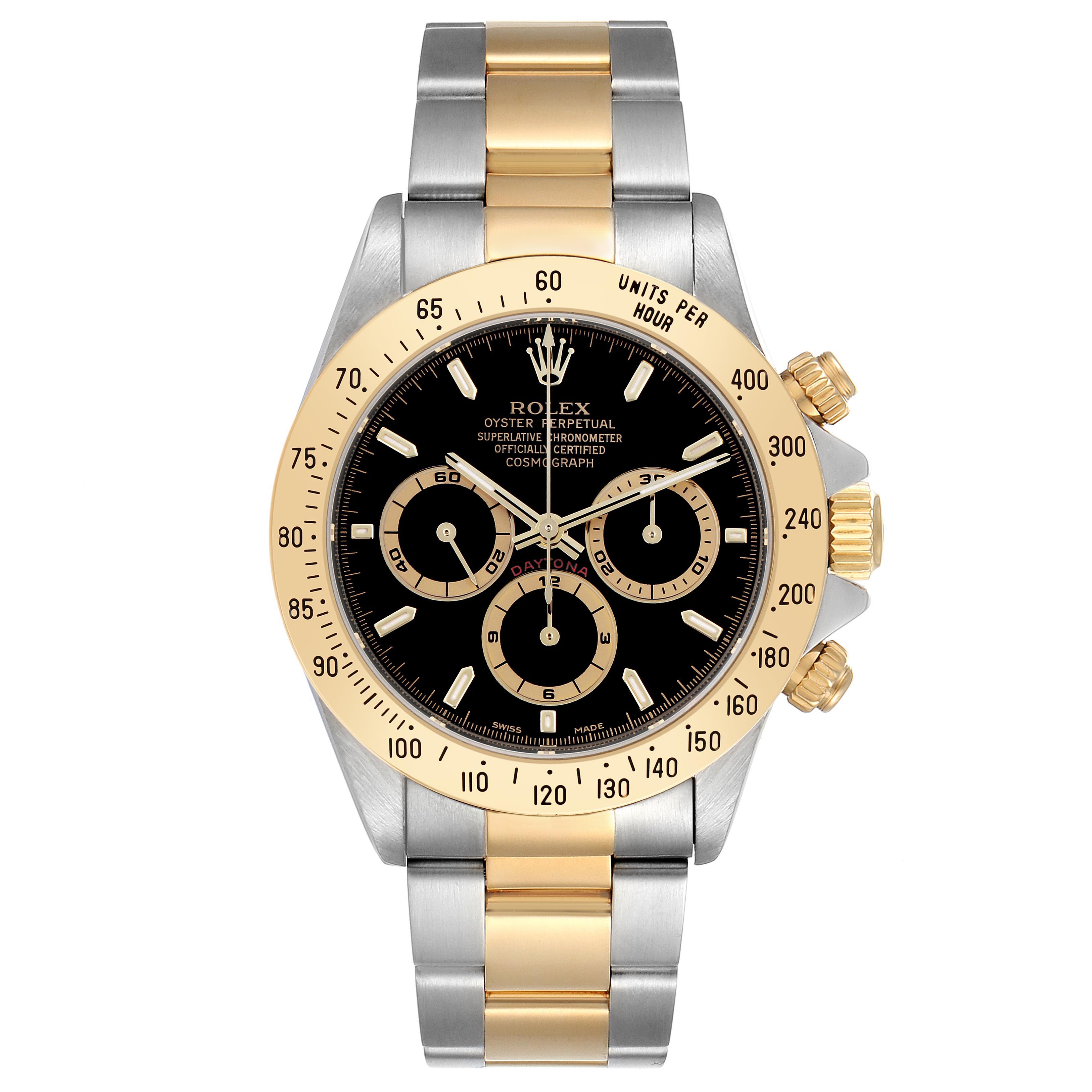 The Rolex Daytona 16523 Men's Steel and Gold (two tone) Black Dial 16523 Men's Steel and Gold (two tone) Black Dial watch is shown from a top-down angle, highlighting its bezel, face, and two-tone bracelet.