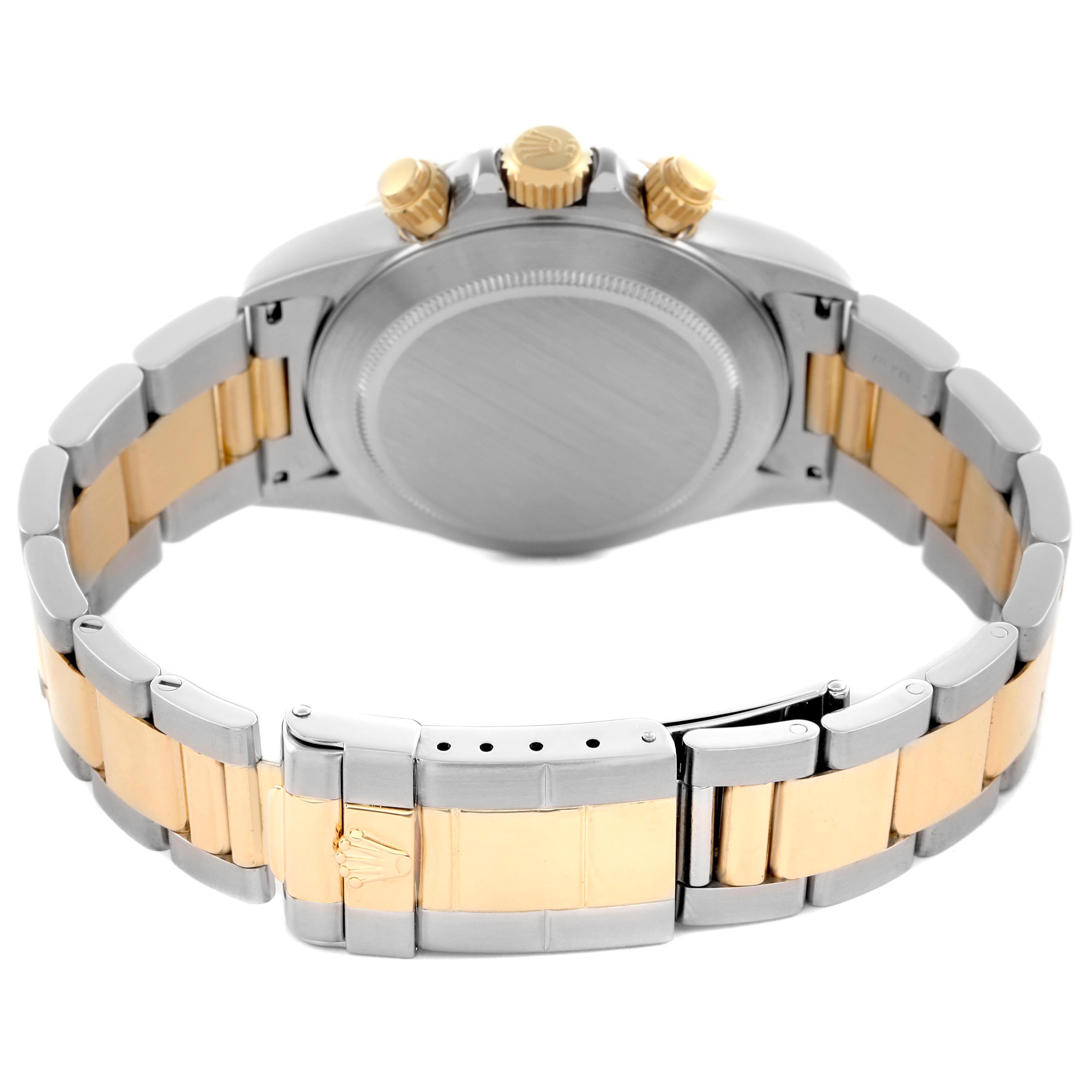 The image shows the back and side profile of the Rolex Daytona 16523 Men's Steel and Gold (two tone) Black Dial 16523 Men's Steel and Gold (two tone) Black Dial, highlighting the clasp and crown, with a two-tone bracelet.