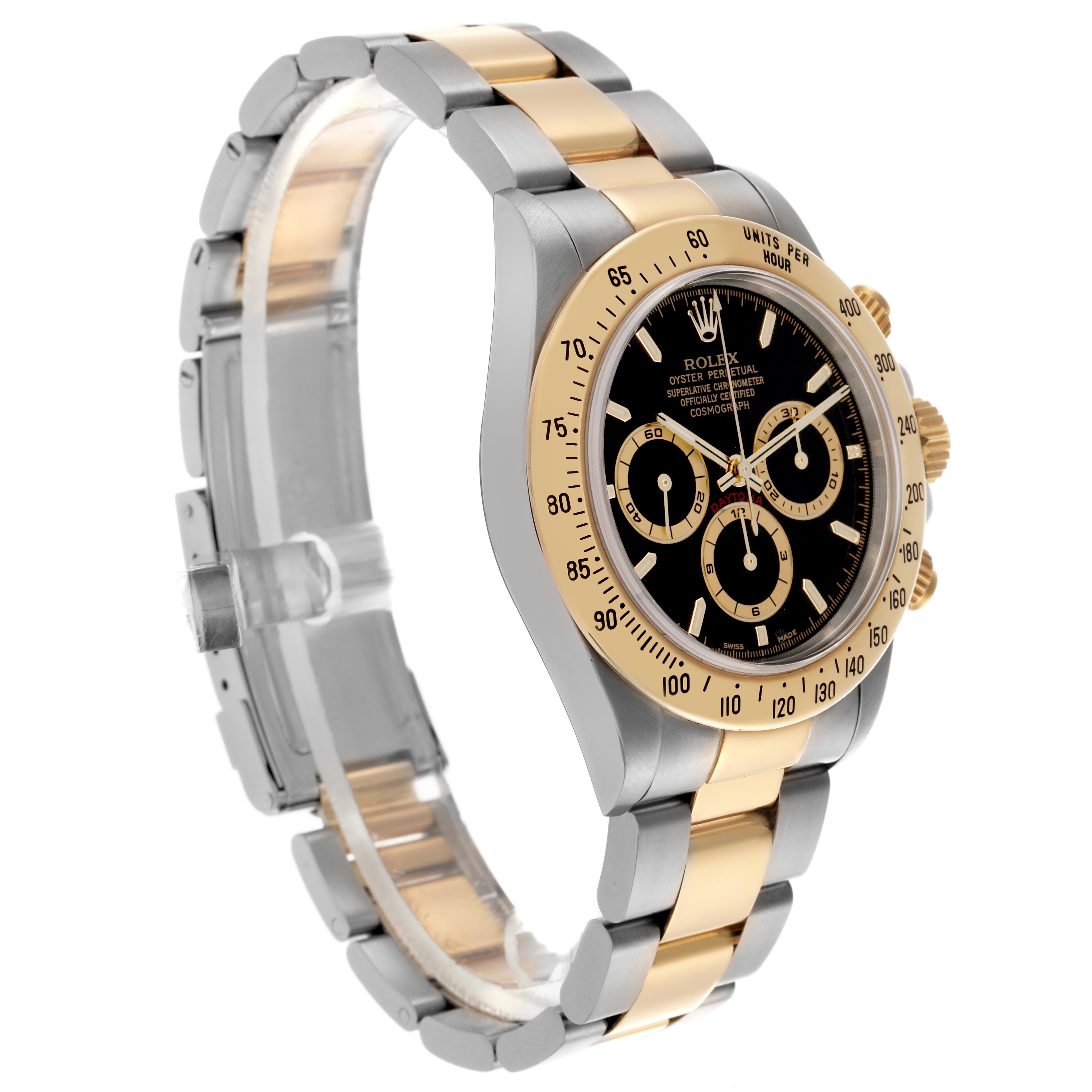 The Rolex Daytona 16523 Men's Steel and Gold (two tone) Black Dial 16523 Men's Steel and Gold (two tone) Black Dial watch is shown at a three-quarter angle, highlighting the face, bezel, and two-tone bracelet.