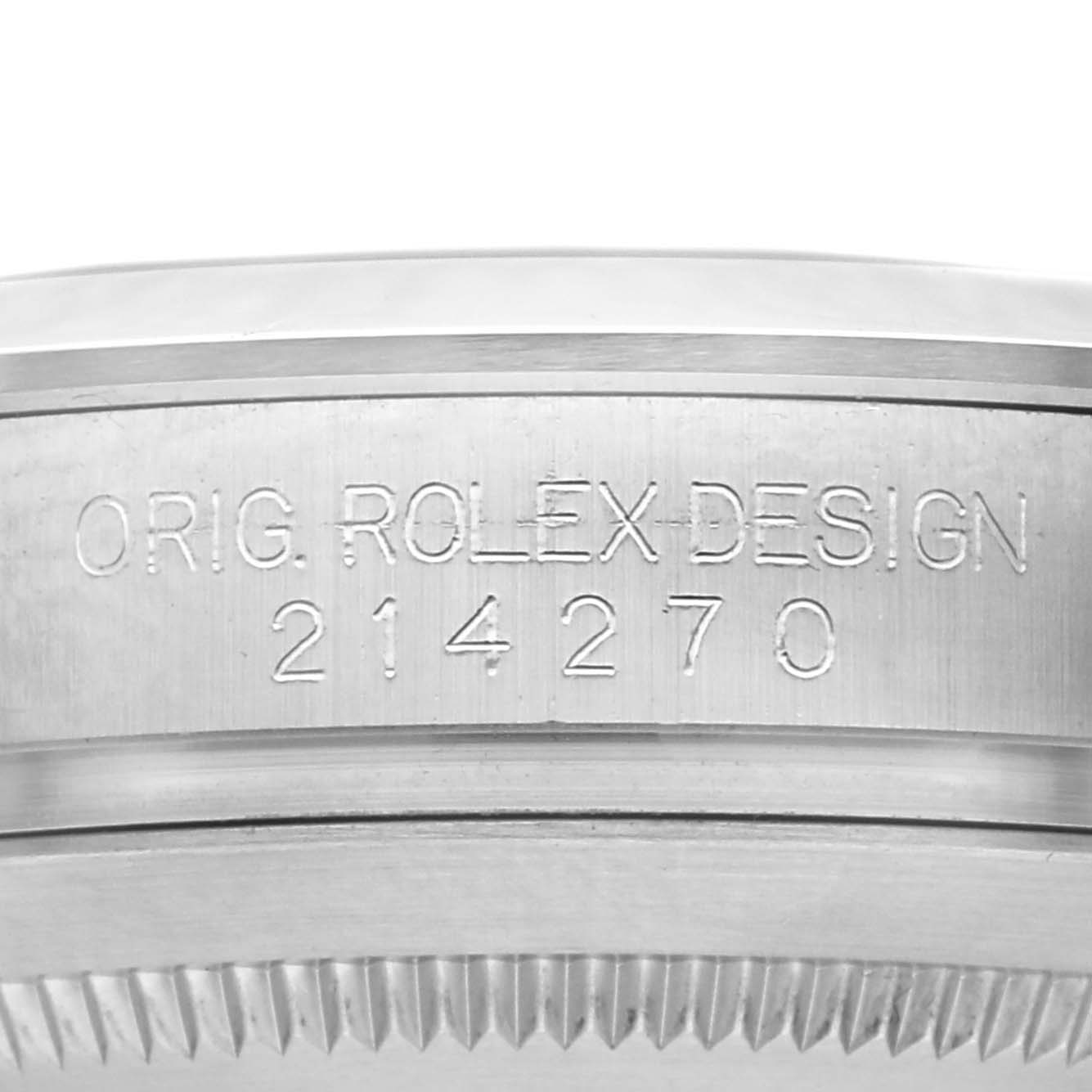 The image shows the edge of a Rolex Explorer 214270 Men's Stainless Steel Black Dial 214270 Men's Stainless Steel Black Dial case with the engraving "ORIG. ROLEX DESIGN 214270."
