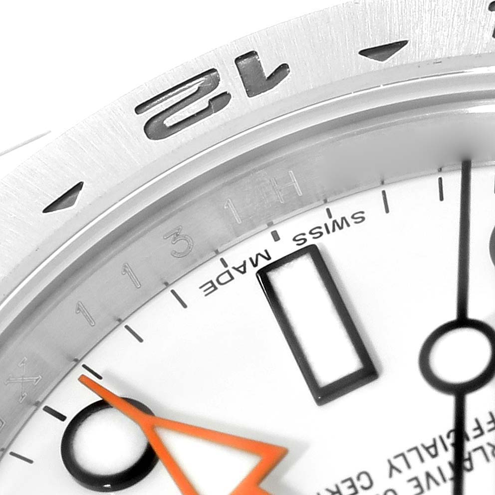 This close-up image shows part of the dial and bezel of a Rolex Explorer 216570 Men's Stainless Steel White Dial 216570 Men's Stainless Steel White Dial watch, focusing on the "12" marker and surrounding details.