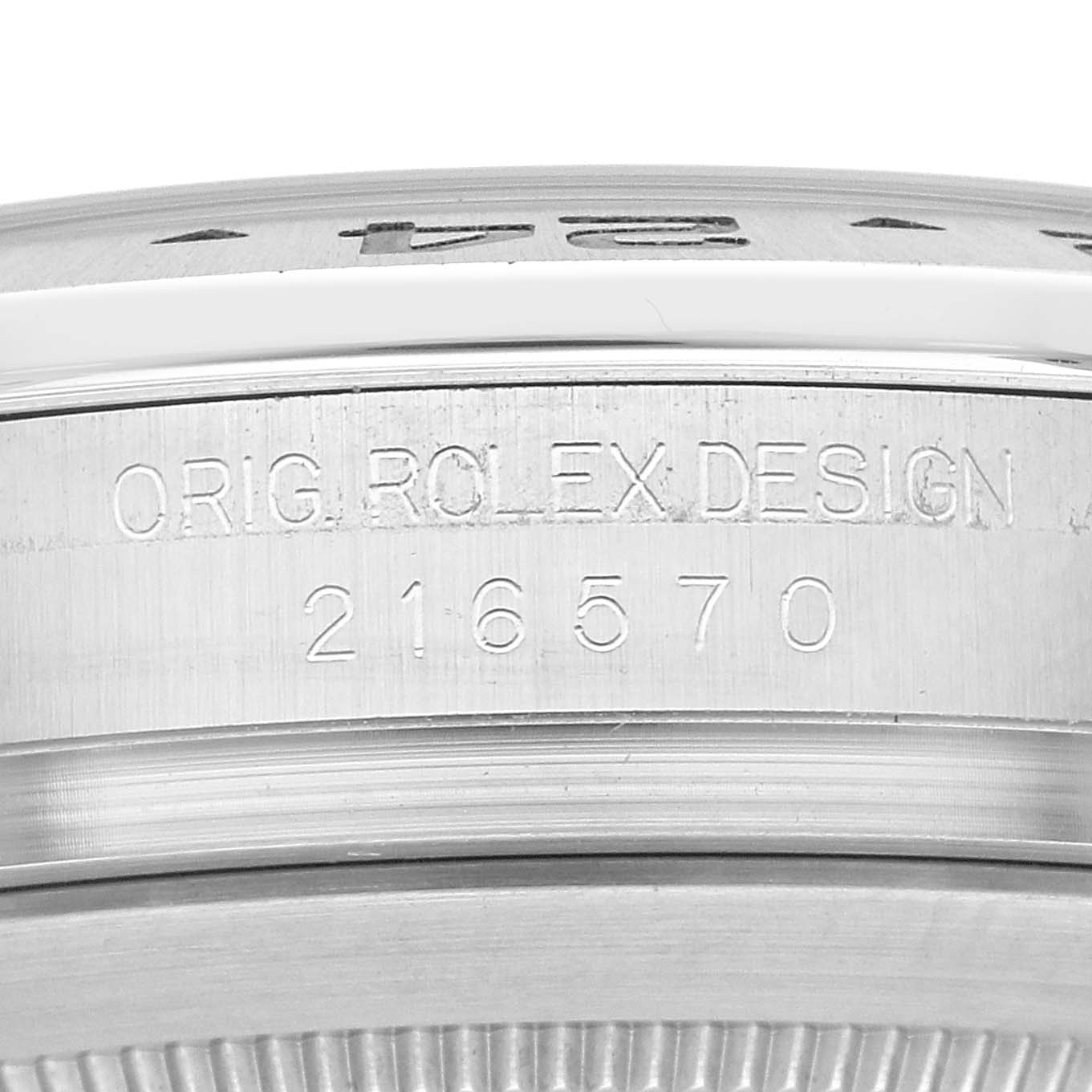 This image shows an engraved close-up of the case side of a Rolex Explorer 216570 Men's Stainless Steel White Dial 216570 Men's Stainless Steel White Dial watch displaying "ORIG ROLEX DESIGN" and the model number 216570.