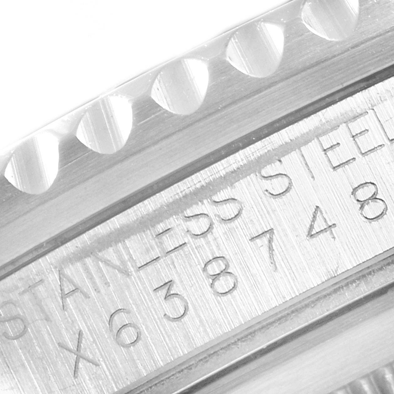 The image shows a close-up of the serial number and "Stainless Steel" engraving on the side of the casing of the Rolex GMT-Master 16700 Men
s Stainless Steel Black Dial 16700 Men
s Stainless Steel Black Dial watch.