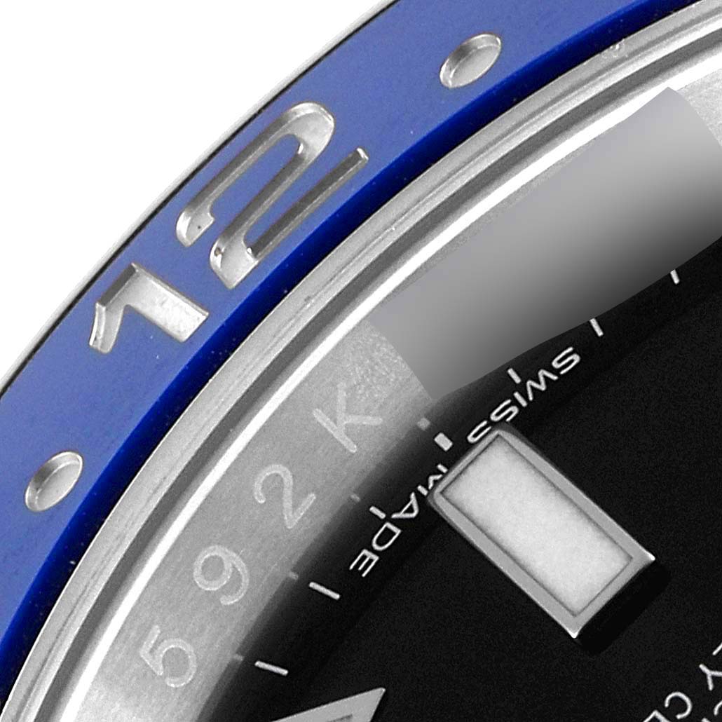 This image shows a close-up of the bezel and part of the dial of a Rolex GMT-Master 116710 BLNR Men
s Stainless Steel Black Dial 116710 BLNR Men
s Stainless Steel Black Dial watch.