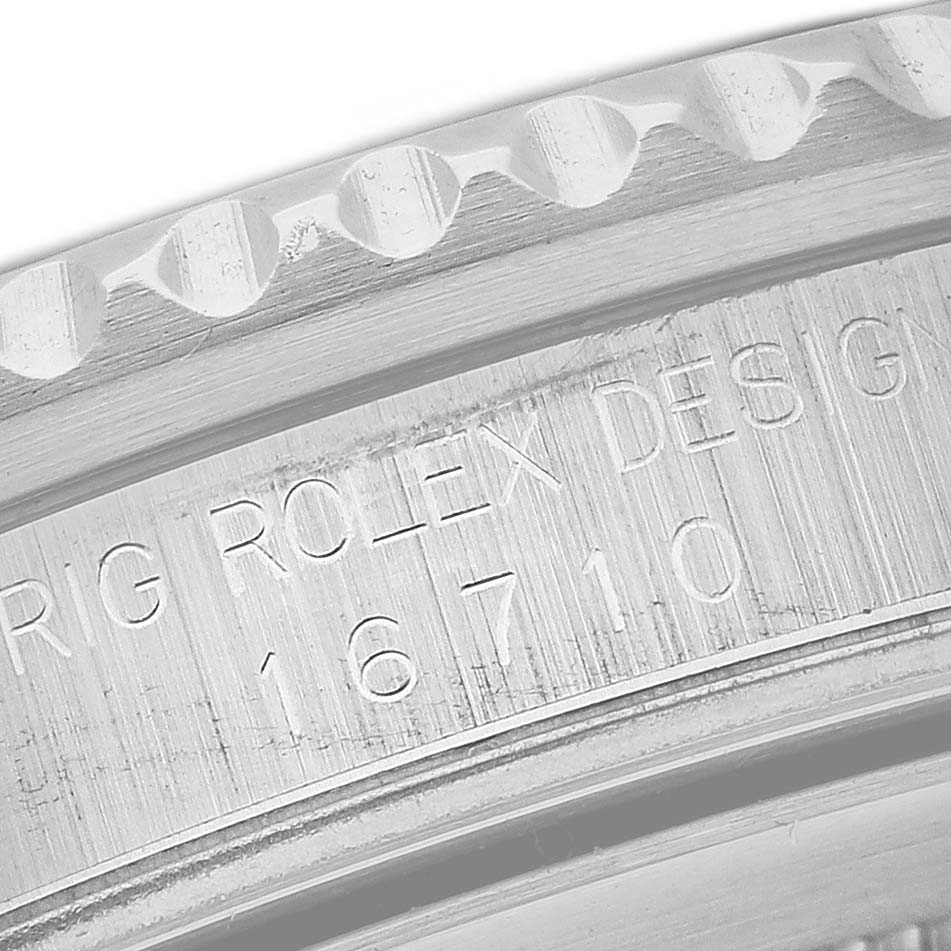 This close-up image shows the side of a Rolex GMT-Master 16710 Men
s Stainless Steel Black Dial 16710 Men
s Stainless Steel Black Dial model watch, highlighting its model number and "Rolex design" engraving.