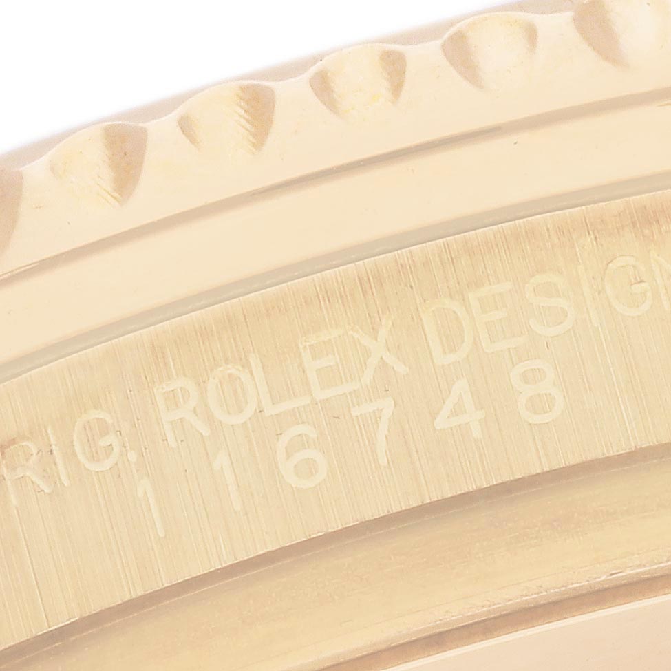 The image displays a close-up of a Rolex GMT-Master 116748 Men's Yellow Gold Black Dial model, focusing on the serrated bezel and engraved model number "116748."