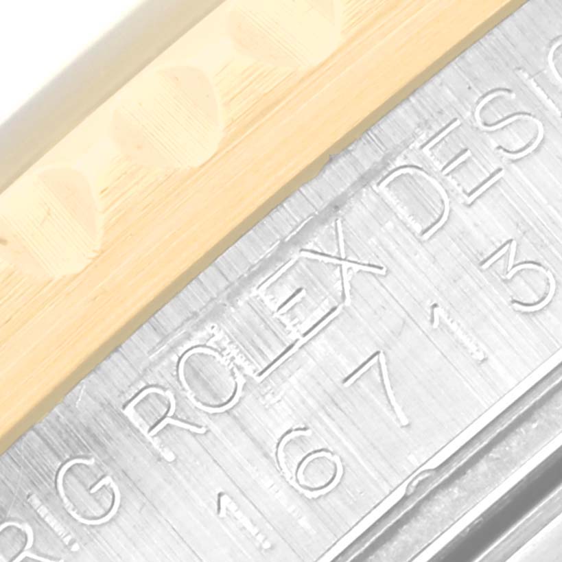 The image is a close-up view showing the engraved side of the Rolex GMT-Master 16713 Men's Steel and Gold (two tone) Black Dial 16713 Men's Steel and Gold (two tone) Black Dial watch case.