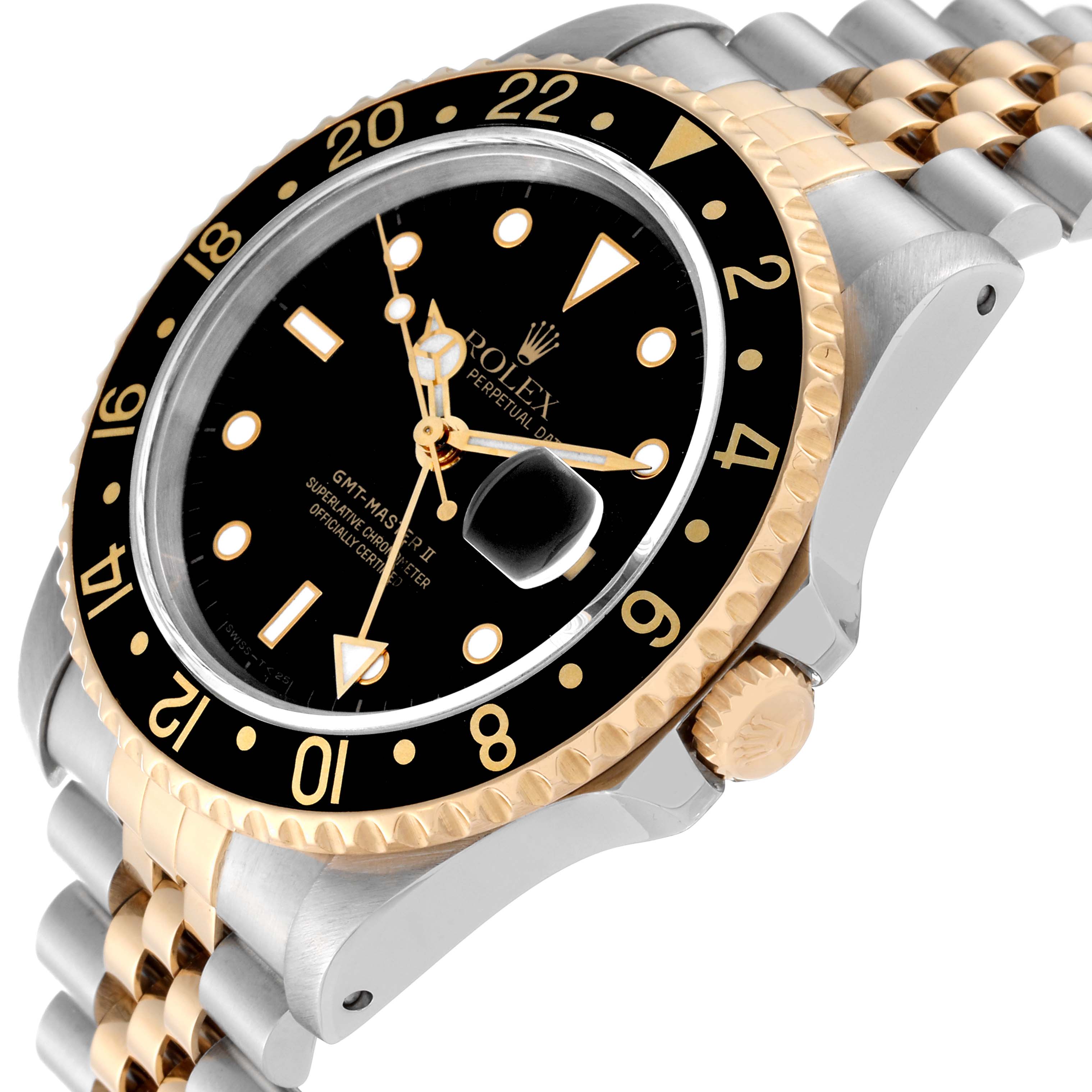 The image shows a close-up angle of a Rolex GMT-Master 16713 Men's Steel and Gold (two tone) Black Dial 16713 Men's Steel and Gold (two tone) Black Dial watch, highlighting the bezel, dial, crown, and part of the bracelet.