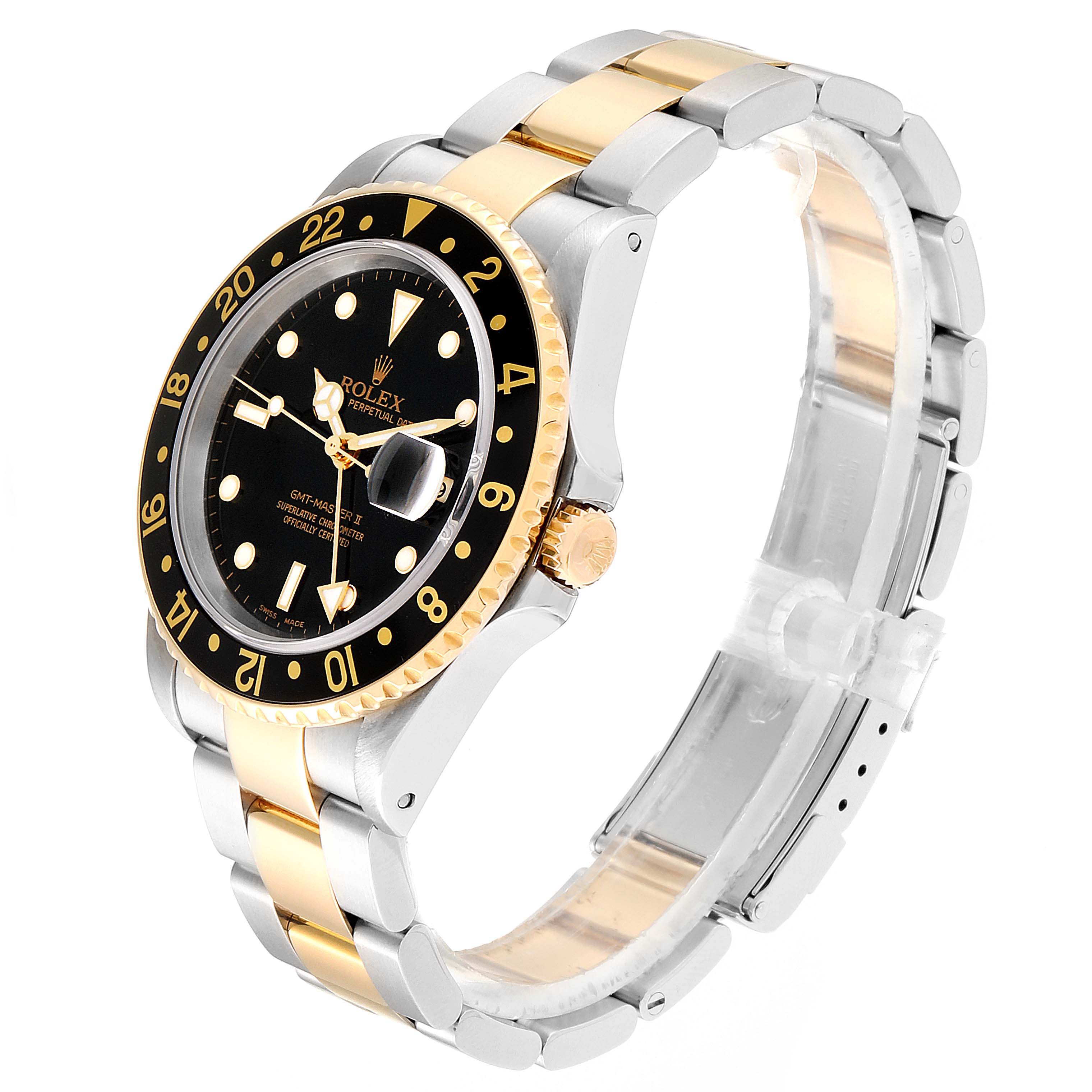 The image shows a side and front angle of the Rolex GMT-Master 16713 Men's Steel and Gold (two tone) Black Dial 16713 Men's Steel and Gold (two tone) Black Dial watch, displaying its dial, bezel, and bracelet.