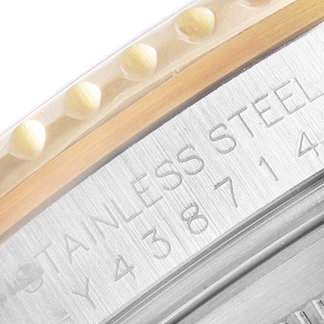 The image shows a close-up angled view of the bezel and case back of a Rolex GMT-Master 16713 Men's Steel and Gold (two tone) Black Dial 16713 Men's Steel and Gold (two tone) Black Dial watch, highlighting "STAINLESS STEEL" engravings.