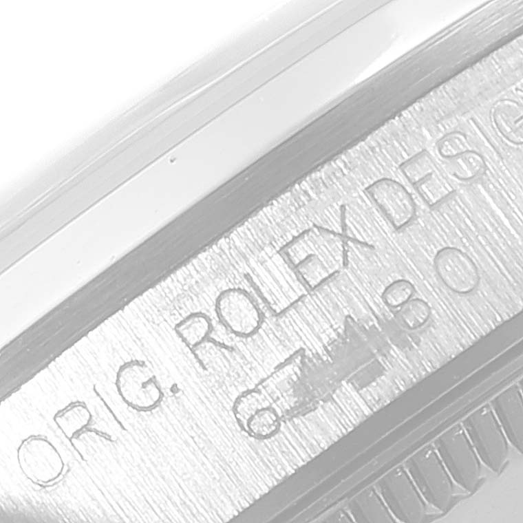 This is a close-up angle showing the engraved text on the side of a Rolex Mid-Size 67480 Women's Stainless Steel Pink Dial 67480 Women's Stainless Steel Pink Dial watch.