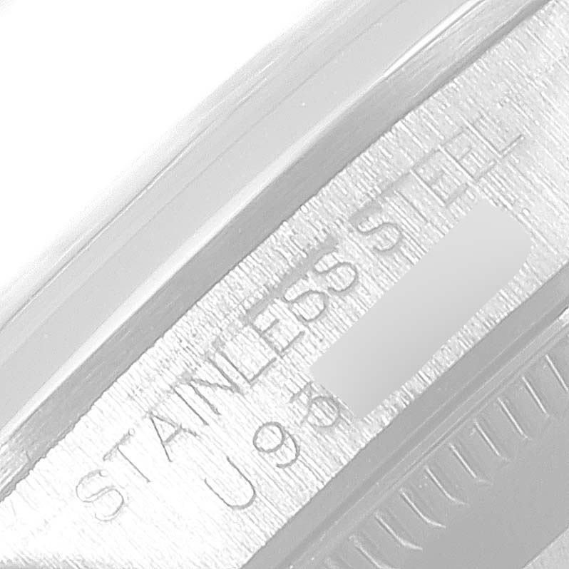 The image shows a close-up of the case side of a Mid-Size Rolex watch, highlighting the "Stainless Steel" engraving.