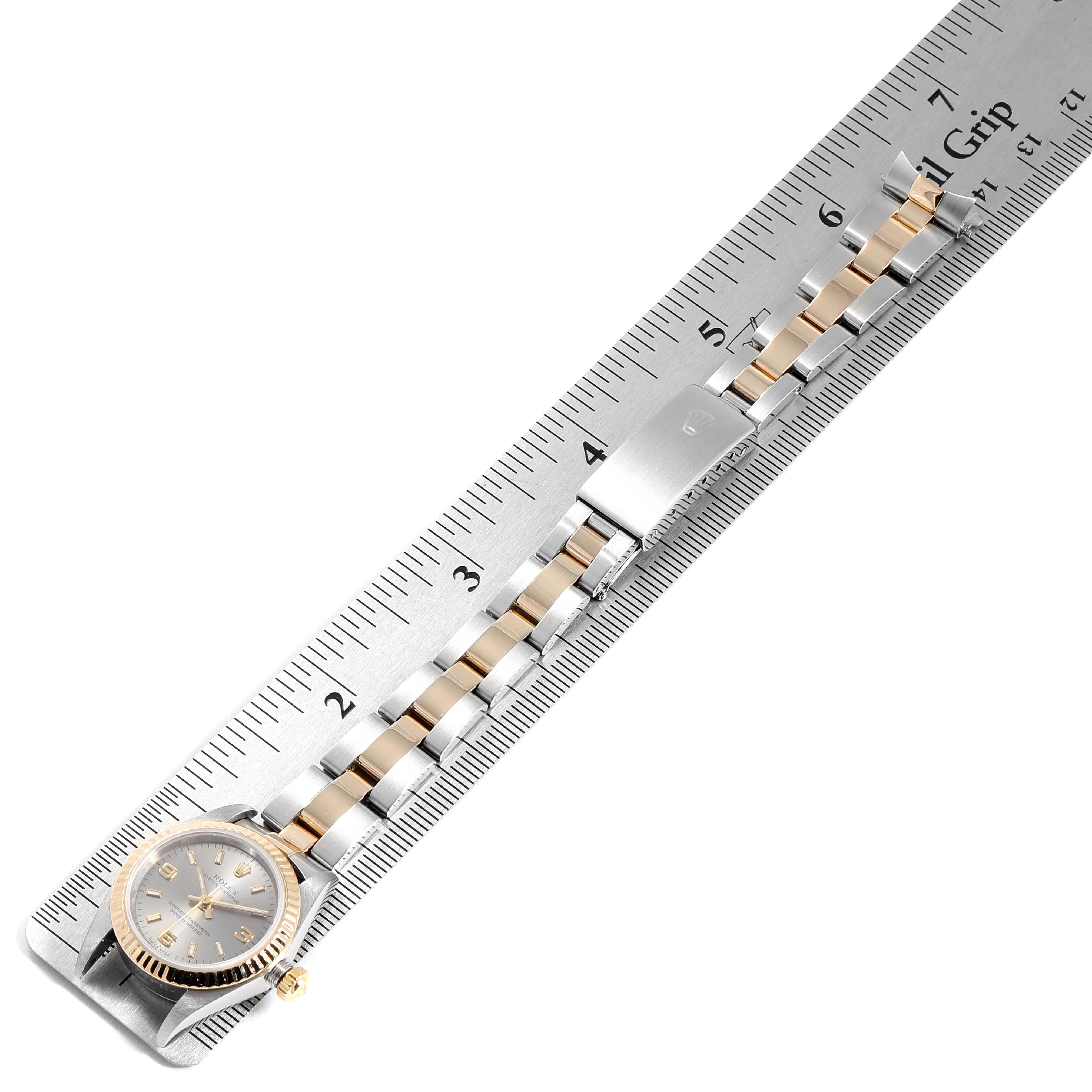 The image shows a Rolex Oyster Perpetual 76193 Women's Stainless Steel Grey Dial 76193 Women's Stainless Steel Grey Dial watch laid flat next to a ruler, displaying the entire watchband and face.