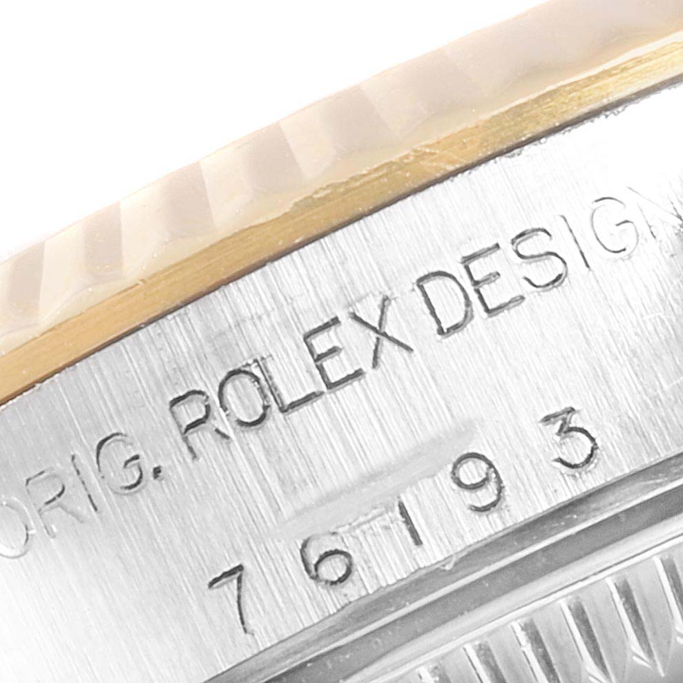 This image shows a close-up of the engraved side of the Rolex Oyster Perpetual 76193 Women's Stainless Steel Grey Dial 76193 Women's Stainless Steel Grey Dial watch case.
