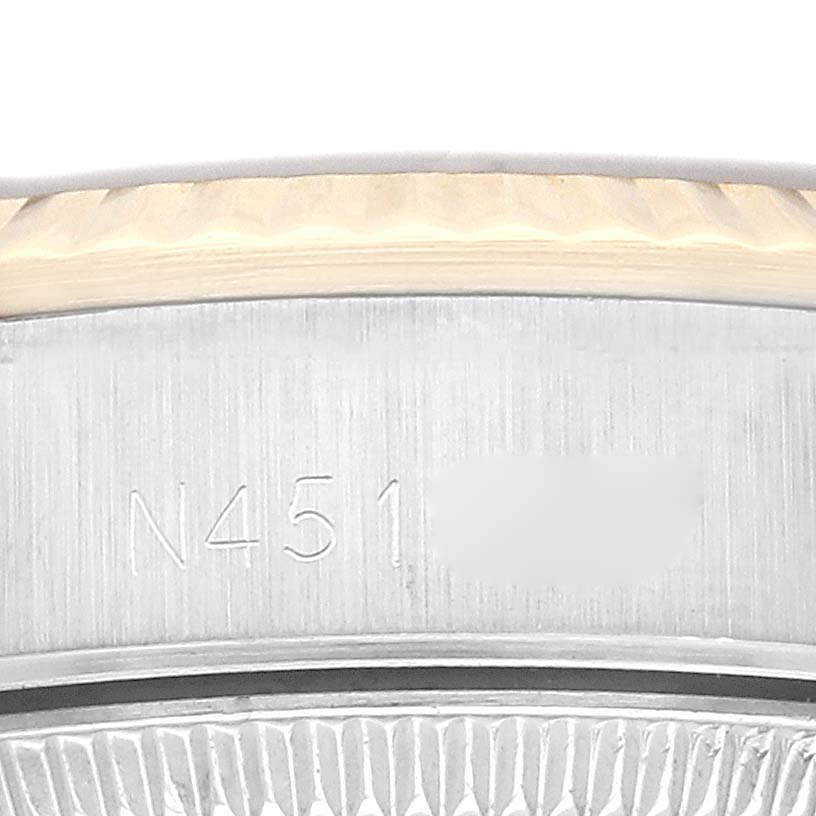 The image shows the serial number engraving on the case back of a Rolex Oyster Perpetual 67193 Women's Steel and Gold (two tone) Champagne Dial 67193 Women's Steel and Gold (two tone) Champagne Dial watch.