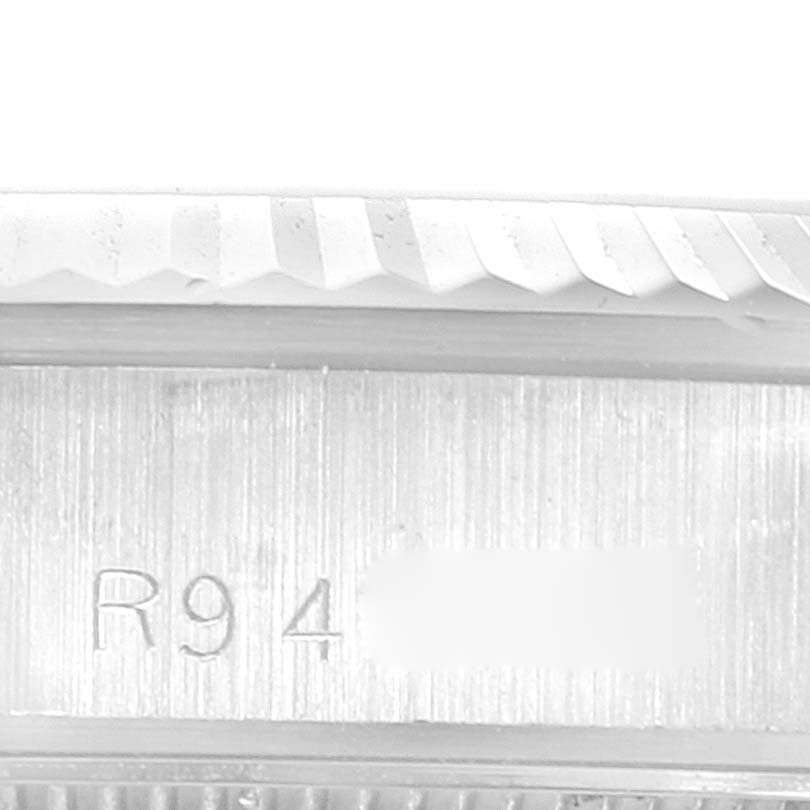 This close-up angle shows the serial number engraving and part of the fluted bezel of the Rolex President 68279 Women's White Gold White Dial 68279 Women's White Gold White Dial model.