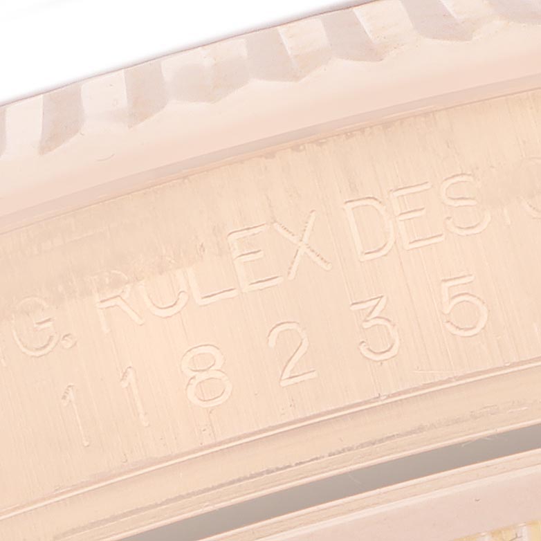 The image shows a close-up of the inner bezel showing the engraved details of a Rolex President 118235 Men's Rose Gold Pink Dial 118235 Men's Rose Gold Pink Dial model watch.