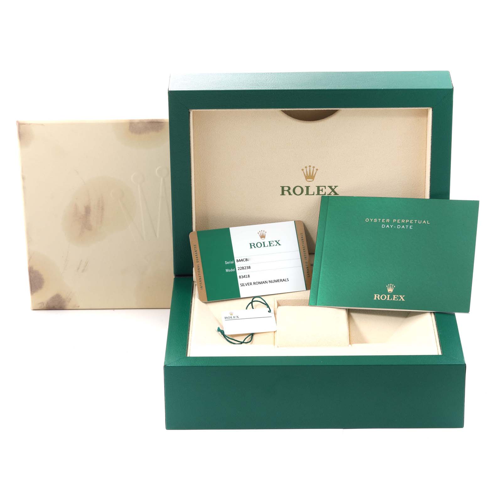 The image shows the box and accessories for the Rolex President 228238 Men
s Yellow Gold Silver Dial 228238 Men
s Yellow Gold Silver Dial model, including the warranty card and booklet.