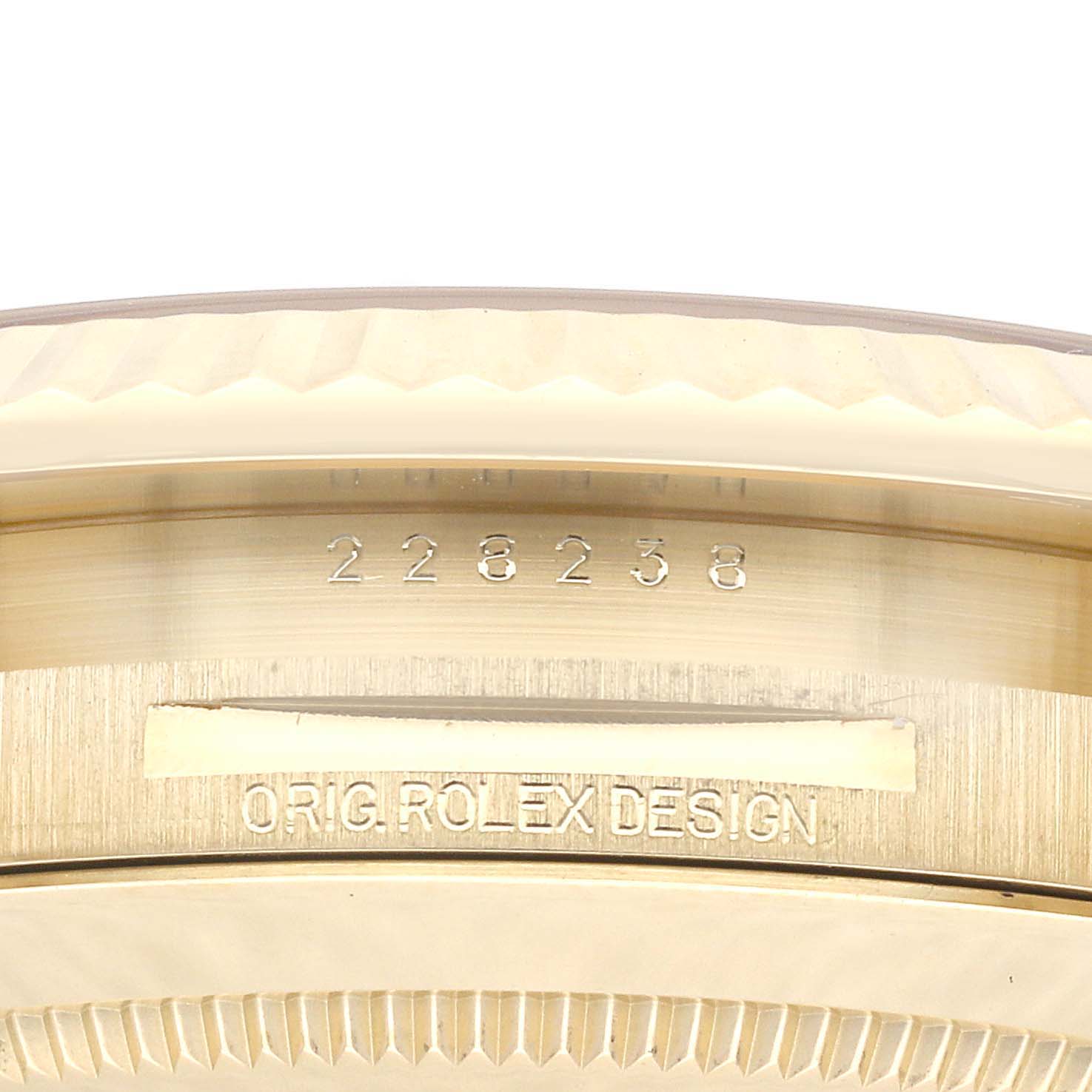 This close-up image shows the engraving and serial number on the case of a Rolex President 228238 Men
s Yellow Gold Silver Dial 228238 Men
s Yellow Gold Silver Dial model watch.