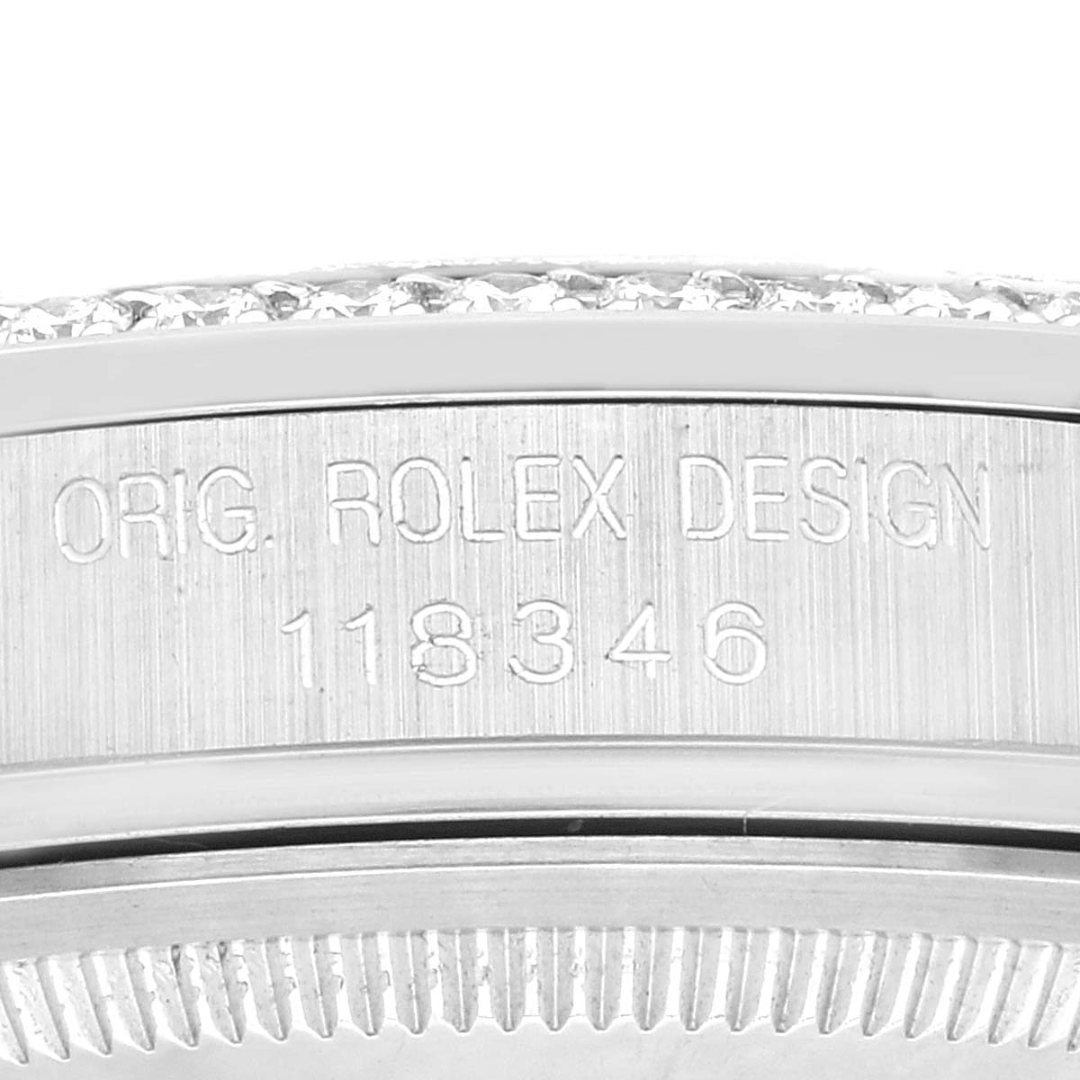 This image shows a close-up of the side engraving of a Rolex President 118346 Men's Platinum Silver Dial 118346 Men's Platinum Silver Dial model watch, displaying the serial number.