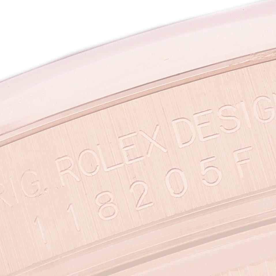 This image shows a close-up of the serial engraving on the side of the Rolex President 118205 Men's Rose Gold Pink Dial 118205 Men's Rose Gold Pink Dial watch case.