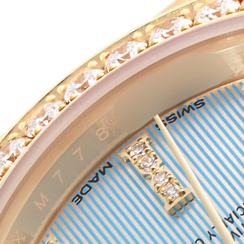 This close-up angle shows part of the dial and gem-encrusted bezel of a Rolex President 279138 Women's Yellow Gold Blue Dial 279138 Women's Yellow Gold Blue Dial model watch.