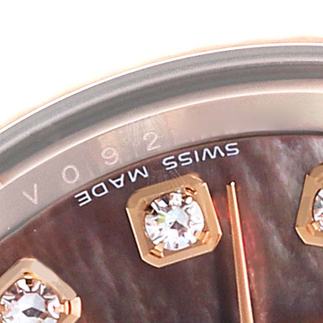 This close-up of the Rolex President 179175 Women's Rose Gold Mother of Pearl Dial 179175 Women's Rose Gold Mother of Pearl Dial watch shows part of the dial with "Swiss Made" text and diamond hour markers. 