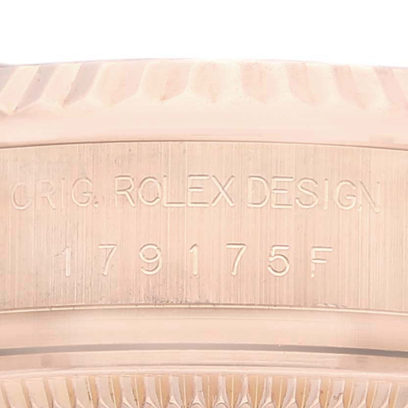 The image shows a close-up of the engraved bezel and inner rim of a Rolex President 179175 Women's Rose Gold Mother of Pearl Dial 179175 Women's Rose Gold Mother of Pearl Dial watch model.