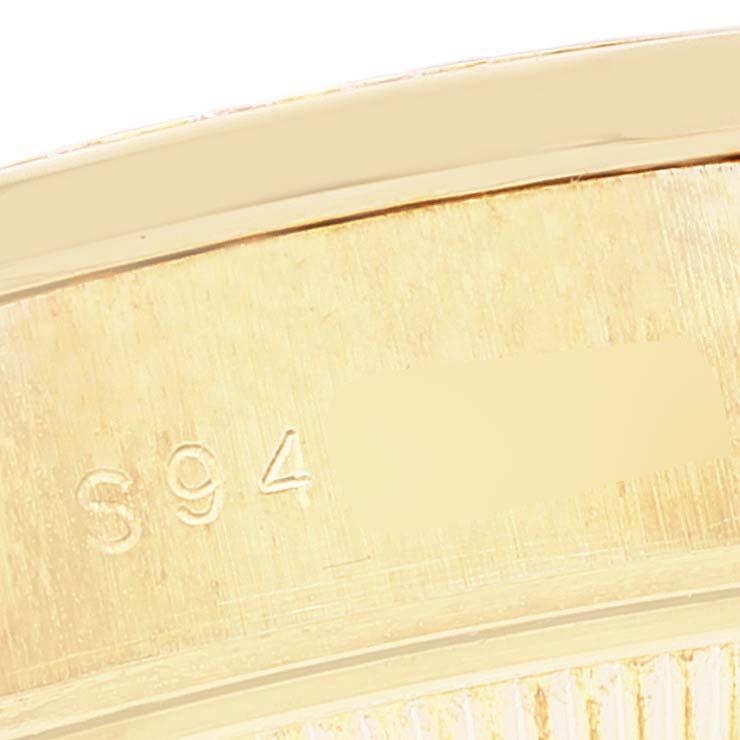 This close-up image shows the engraved serial number on the interior case of a Rolex President 69158 Women's Yellow Gold Mother of Pearl Dial 69158 Women's Yellow Gold Mother of Pearl Dial watch.