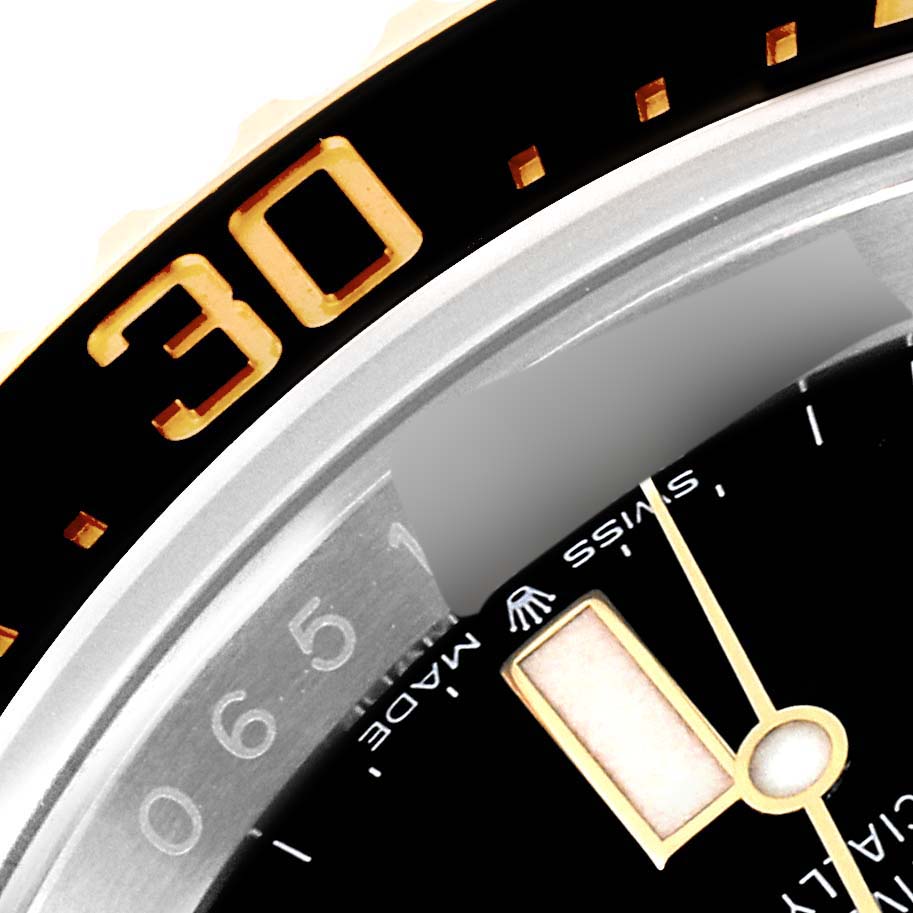 This close-up image of the Rolex Sea-Dweller 126603 Men's Steel and Gold (two tone) Black Dial 126603 Men's Steel and Gold (two tone) Black Dial watch shows the bezel and a portion of the dial.