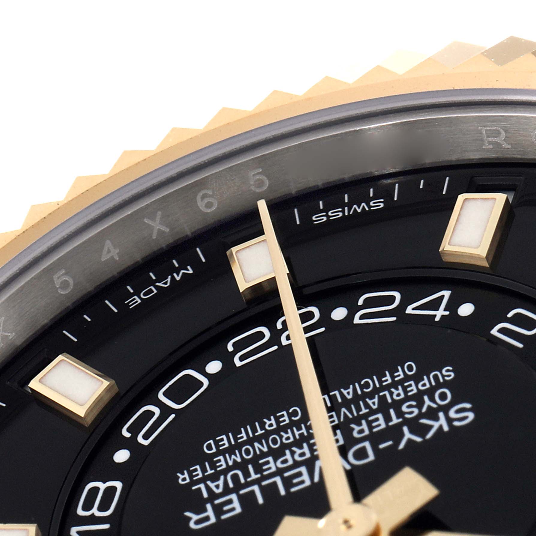 The image shows a close-up angle of the dial, bezel, and tip of the hand of a Rolex Sky-Dweller 326933 Men's Steel and Gold (two tone) Black Dial 326933 Men's Steel and Gold (two tone) Black Dial watch.