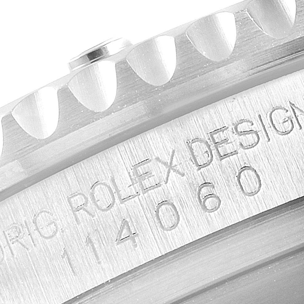 The image shows a close-up of the bezel and case side of a Rolex Submariner 114060 Men
s Stainless Steel Black Dial 114060 Men
s Stainless Steel Black Dial watch with visible engraving.