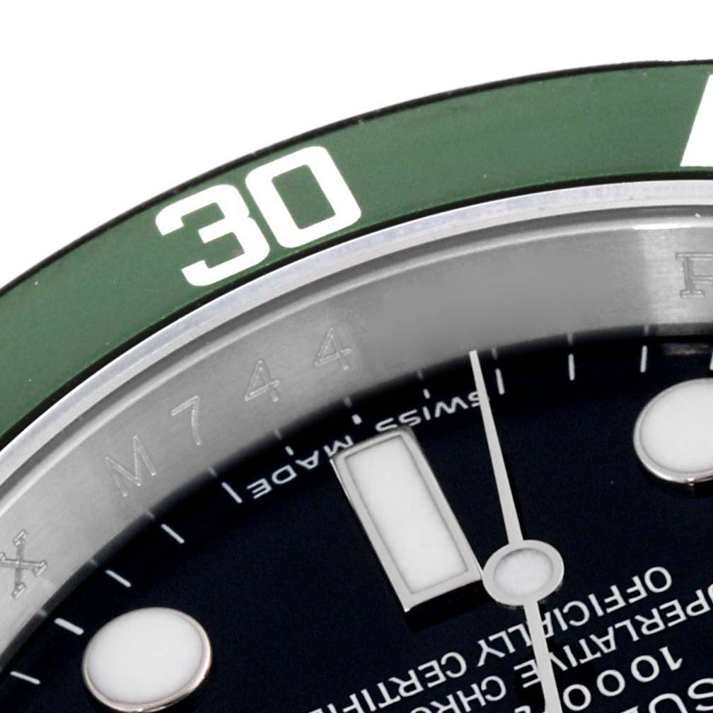 This close-up image shows part of the green bezel, minute markers, and dial of the Rolex Submariner 16610LV Men
s Stainless Steel Black Dial 16610LV Men
s Stainless Steel Black Dial watch.