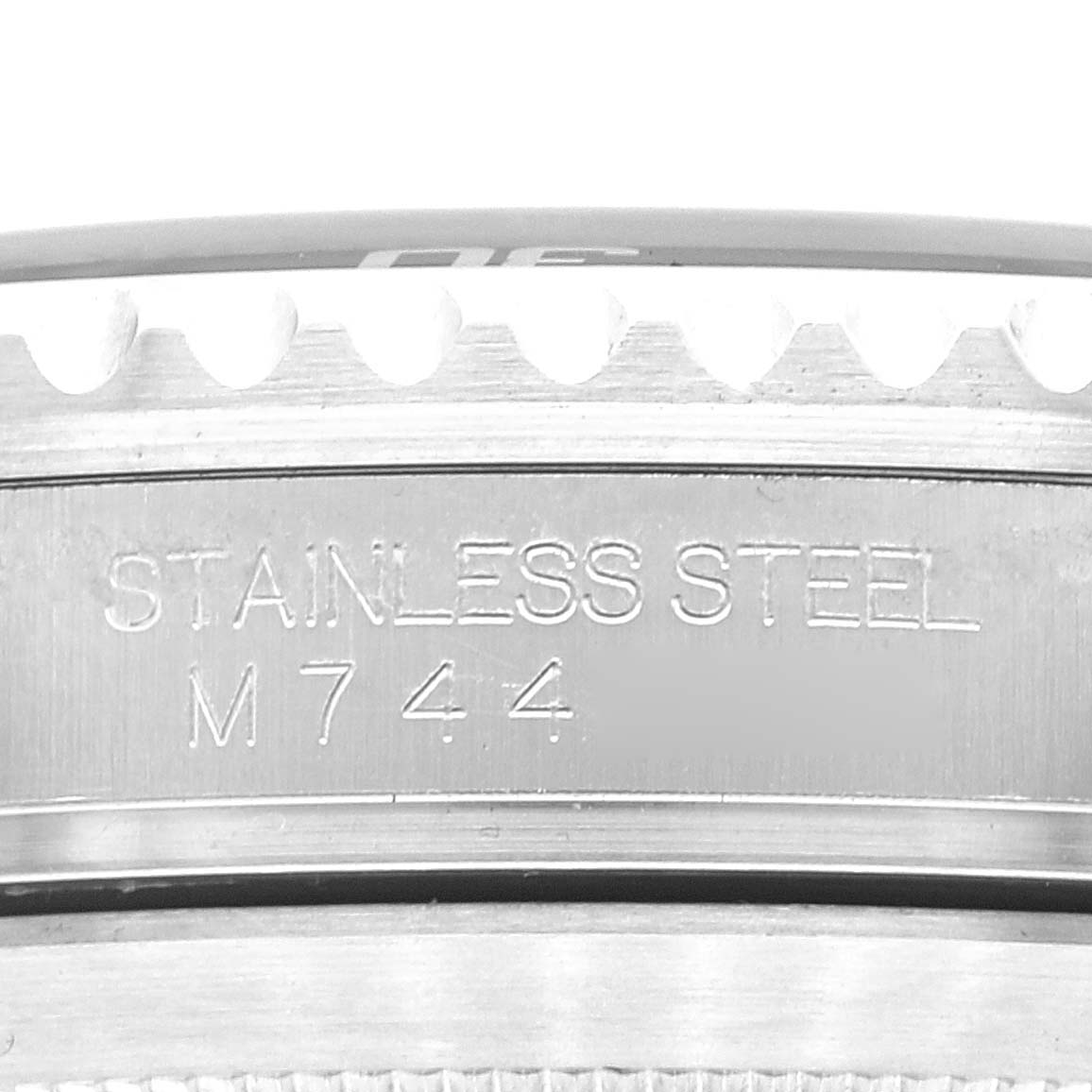 This image shows an angled close-up of the bezel and case back of a Rolex Submariner 16610LV Men
s Stainless Steel Black Dial 16610LV Men
s Stainless Steel Black Dial watch, highlighting the "STAINLESS STEEL" engraving.