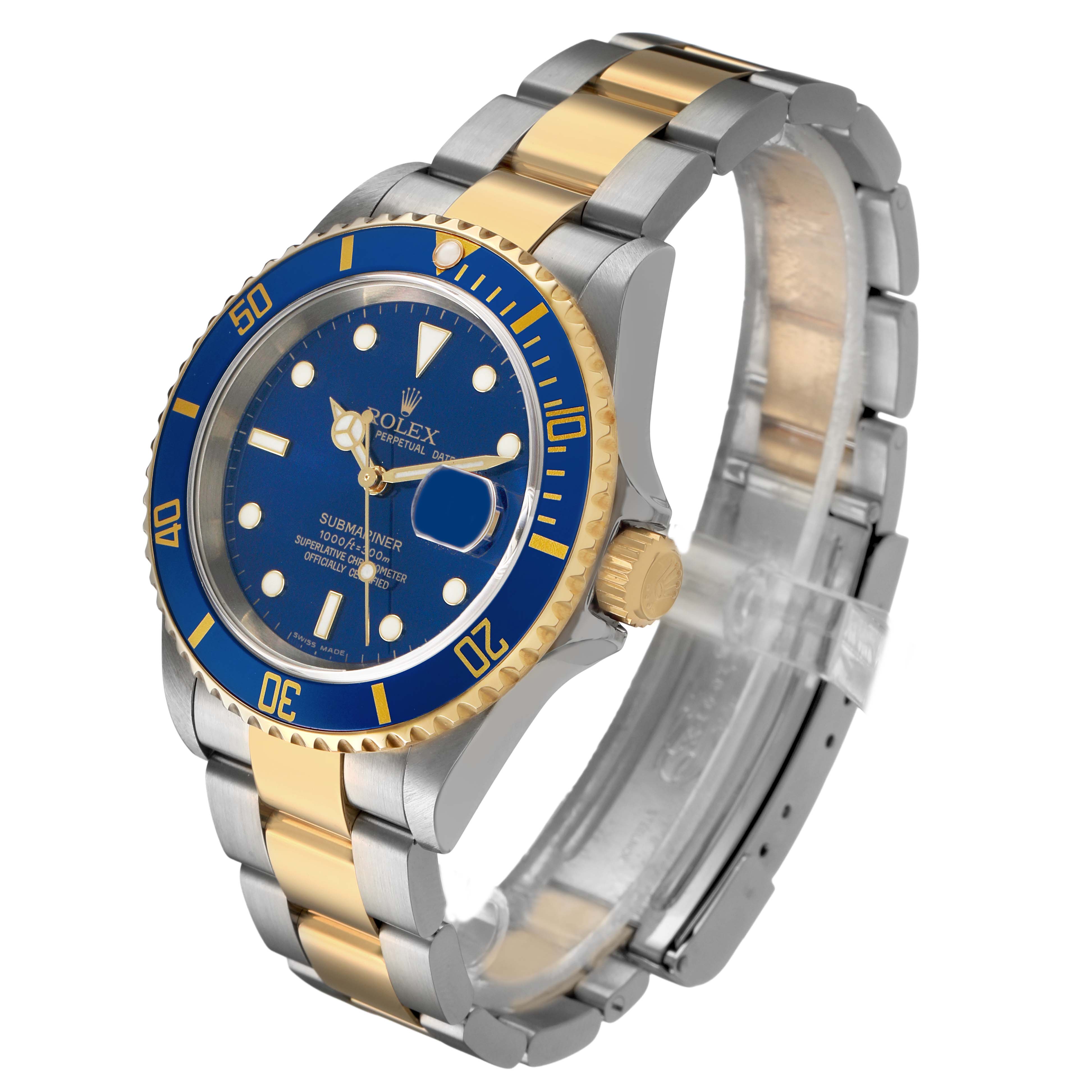 The Rolex Submariner 16613 Men's Steel and Gold (two tone) Blue Dial is shown at a three-quarter angle, highlighting the blue dial, bezel, and the two-tone bracelet.