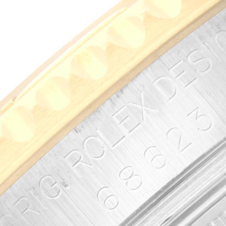 The image shows a close-up of the Rolex Yacht-Master 68623 Men's Steel and Gold (two tone) Grey Dial 68623 Men's Steel and Gold (two tone) Grey Dial highlighting the bezel and part of the engraved case.