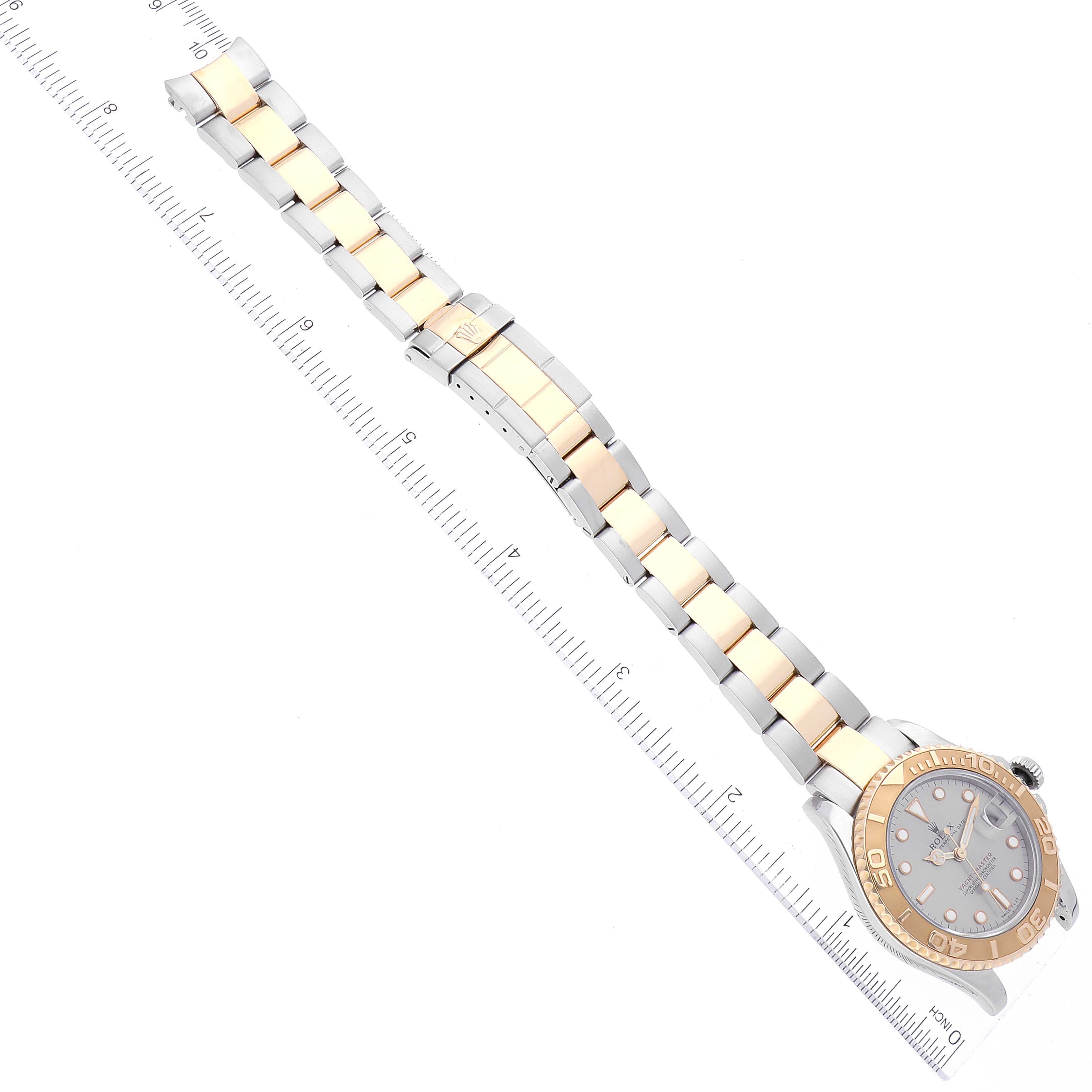 This image shows the Rolex Yacht-Master 68623 Men's Steel and Gold (two tone) Grey Dial 68623 Men's Steel and Gold (two tone) Grey Dial watch, focusing on the entire bracelet and face at an angled, top-down view, with a ruler beside it.