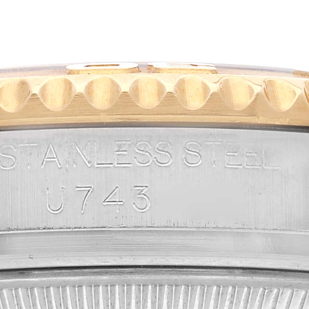 This close-up of the Rolex Yacht-Master 68623 Men
s Steel and Gold (two tone) White Dial 68623 Men
s Steel and Gold (two tone) White Dial watch shows the side of the case, highlighting the stainless steel engraving and part of the bezel.