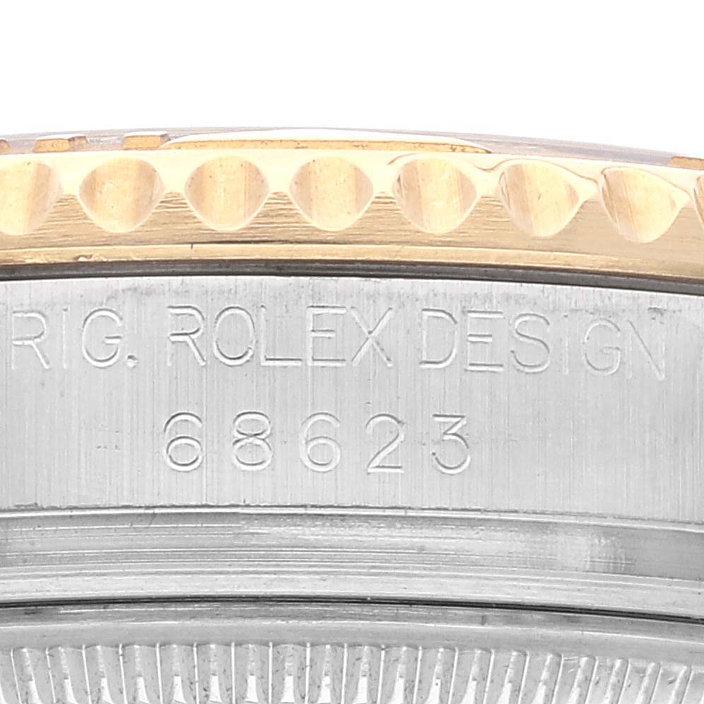 This close-up image shows the side engraving and part of the bezel on a Rolex Yacht-Master 68623 Men
s Steel and Gold (two tone) White Dial 68623 Men
s Steel and Gold (two tone) White Dial watch.
