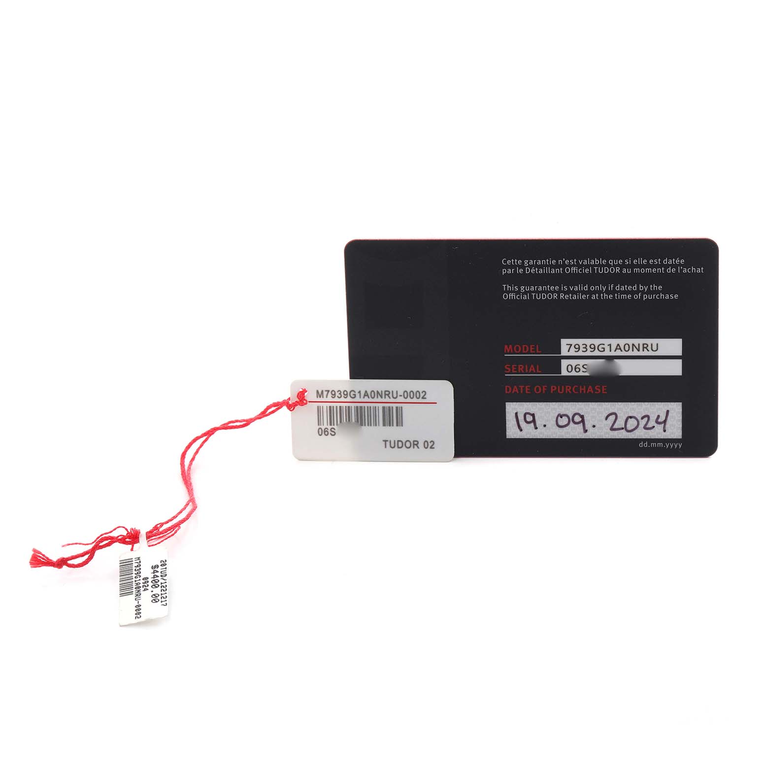 The image shows the warranty card and tags for a Tudor Heritage Black Bay M7939G1A0NRU-0002 Men
s Stainless Steel Black Dial M7939G1A0NRU-0002 Men
s Stainless Steel Black Dial watch.