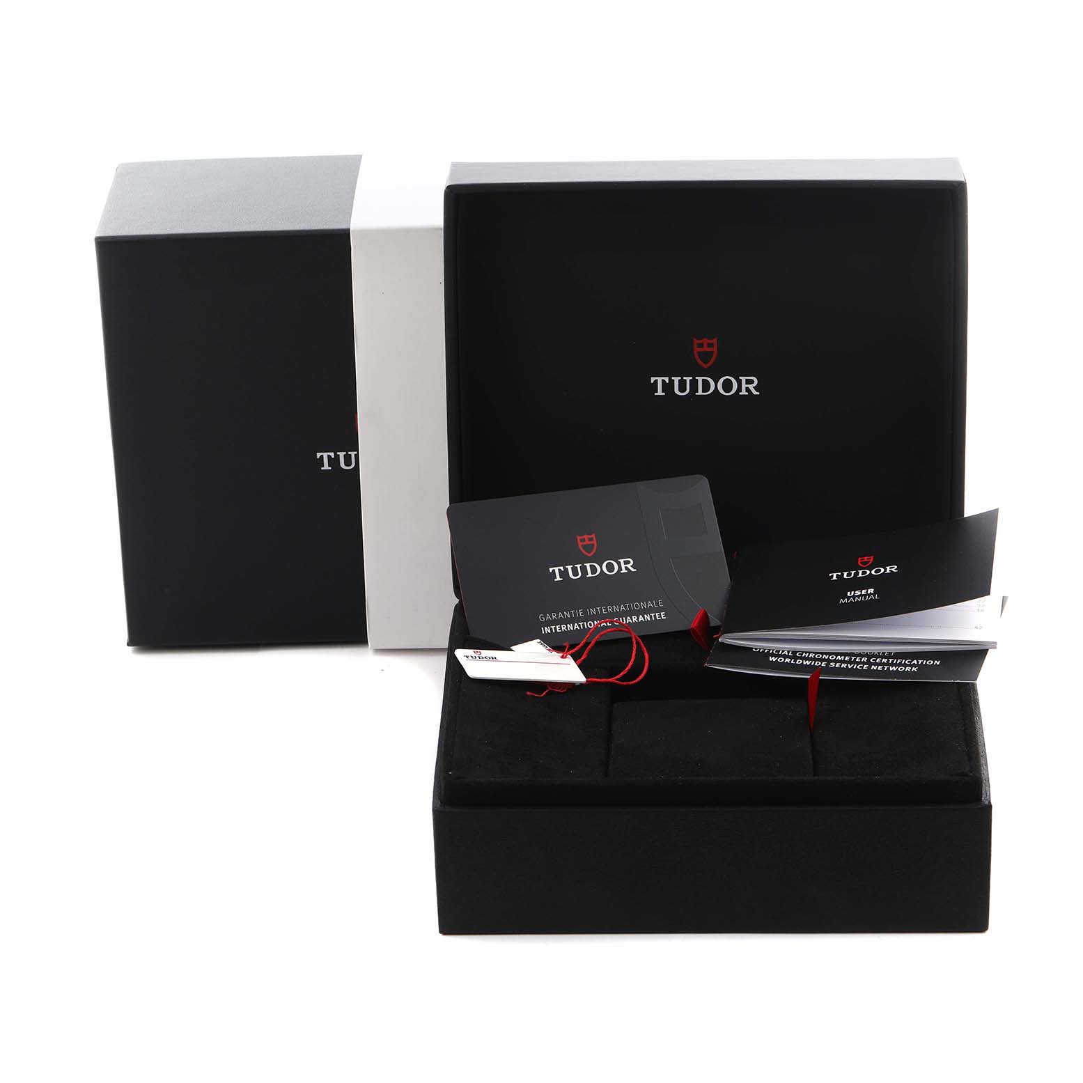 The image shows packaging and documentation for a Tudor Heritage Black Bay M7939G1A0NRU-0002 Men
s Stainless Steel Black Dial M7939G1A0NRU-0002 Men
s Stainless Steel Black Dial watch, including a box and manuals.
