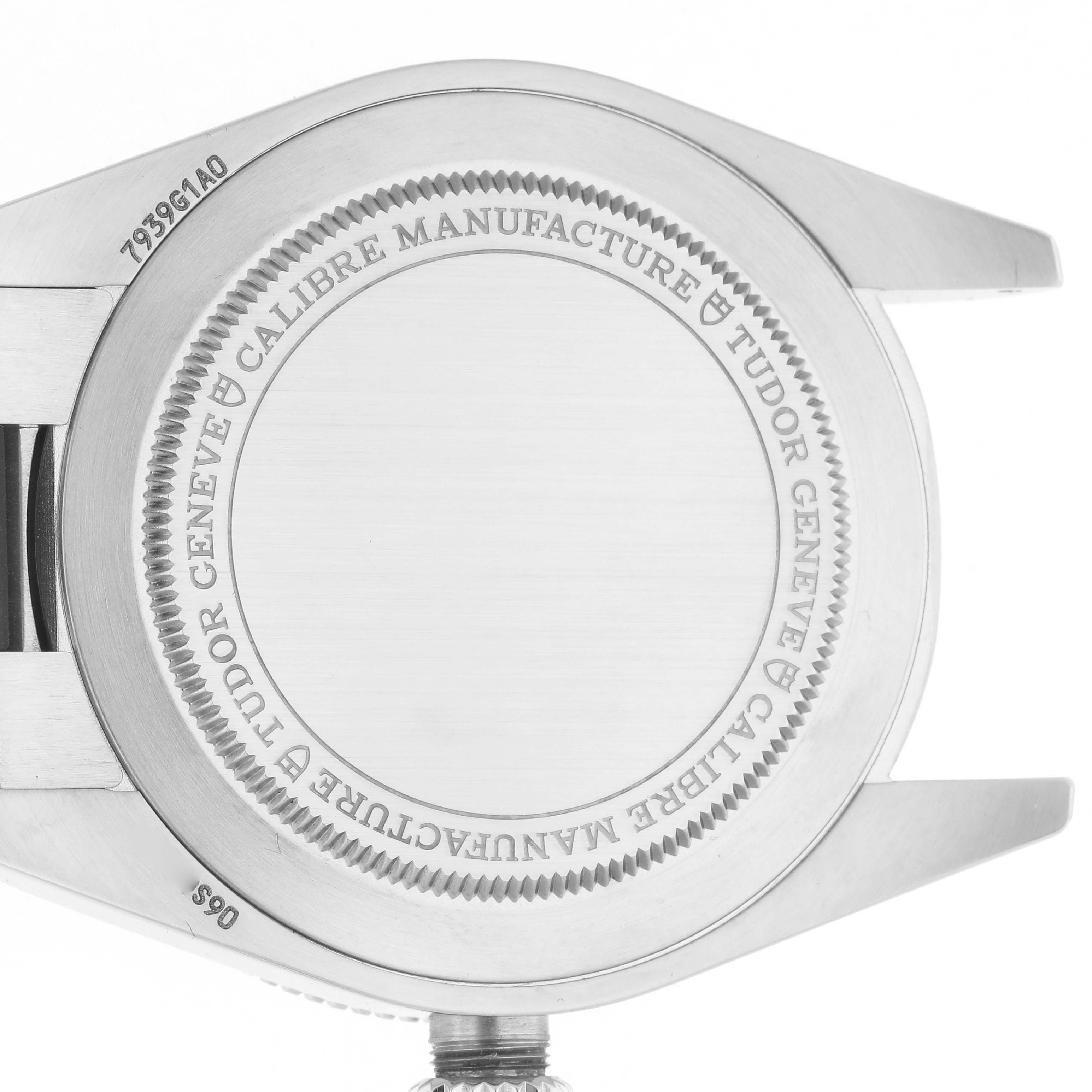 The image shows the back case of a Tudor Heritage Black Bay M7939G1A0NRU-0002 Men
s Stainless Steel Black Dial M7939G1A0NRU-0002 Men
s Stainless Steel Black Dial watch from a rear angle, highlighting engravings and lugs.